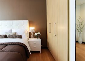 Elegant bedroom with modern furniture, soft lighting, and cozy ambiance.